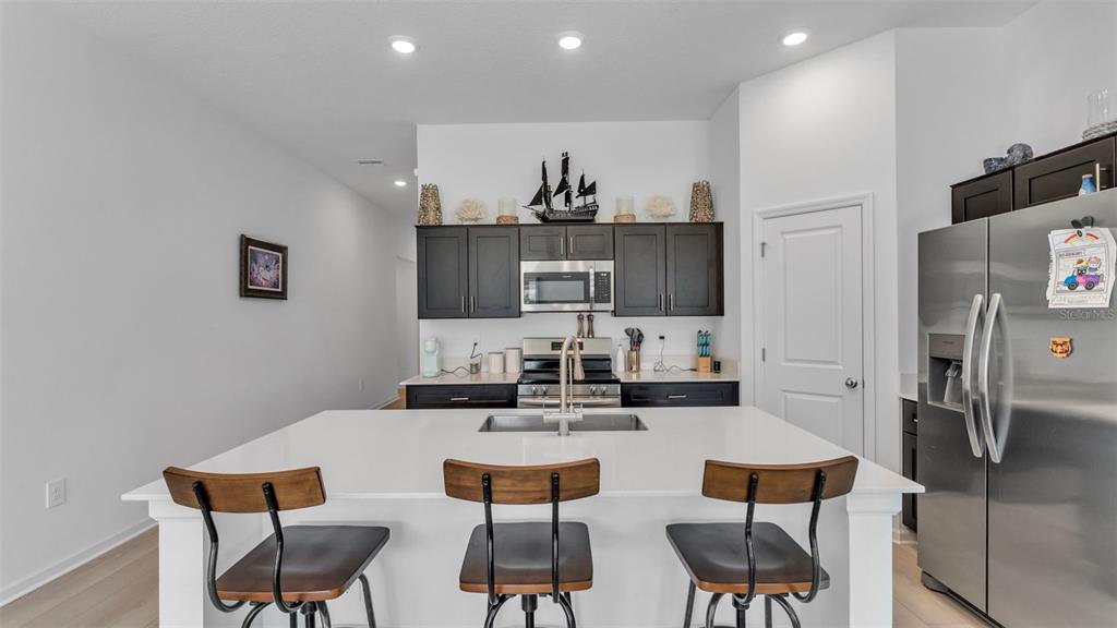 1624 Marksman Road Eagle Lake, FL 33839 - Photo 5 of 42 a kitchen with stainless steel appliances a dining table and chairs