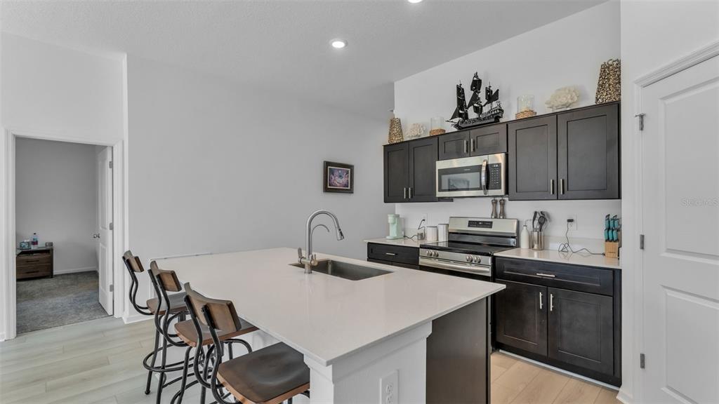 1624 Marksman Road Eagle Lake, FL 33839 - Photo 6 of 42 a kitchen with a table chairs microwave and cabinets