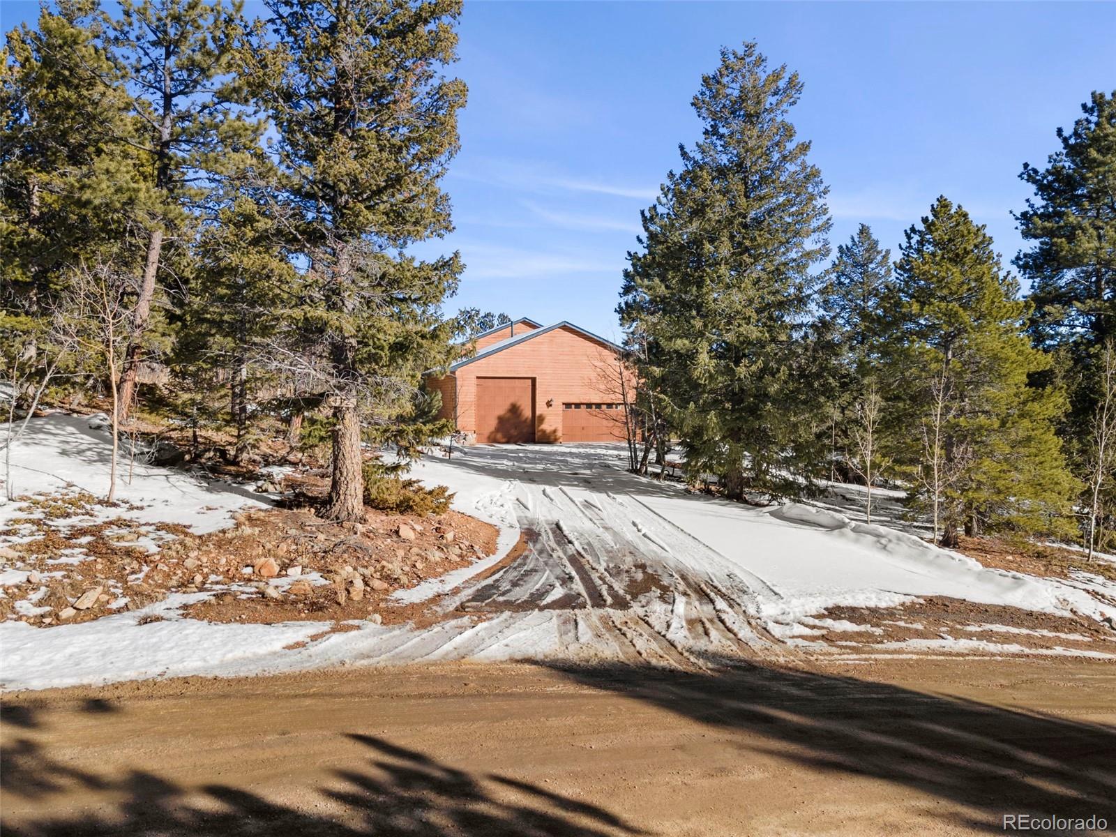 412 Evergreen Road Black Hawk, CO 80422 - Photo 2 of 48 a view of a house with snow on the road