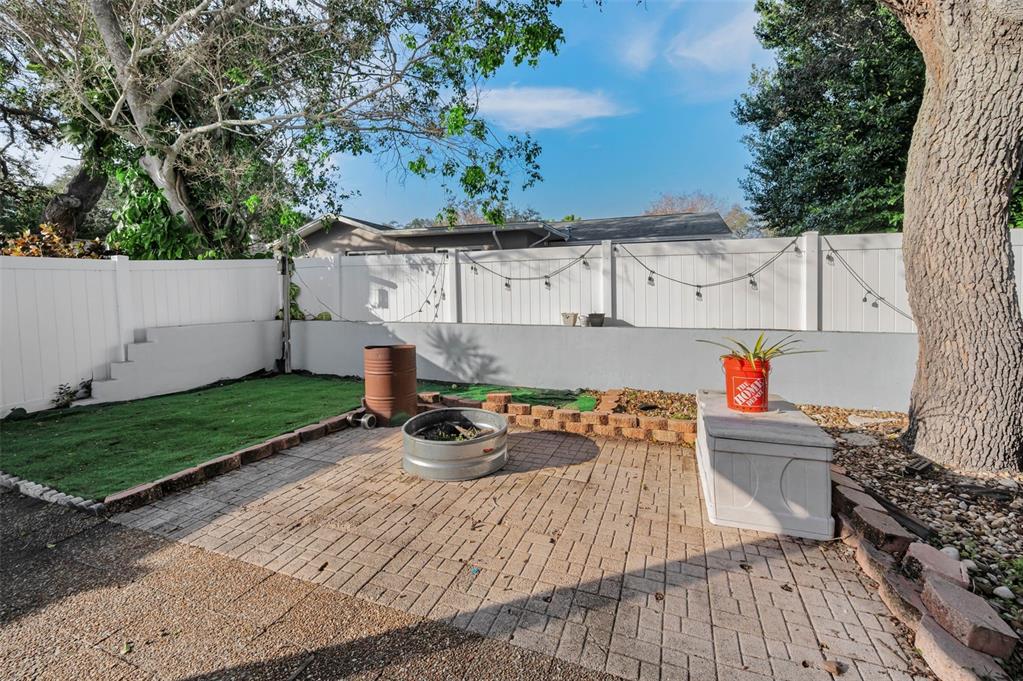 14557 Apache Avenue Largo, FL 33774 - Photo 17 of 51 a backyard of a house with table and chairs