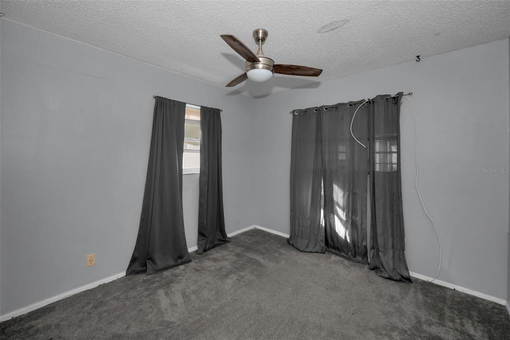 14557 Apache Avenue Largo, FL 33774 - Photo 20 of 51 an empty room with closet and a ceiling fan