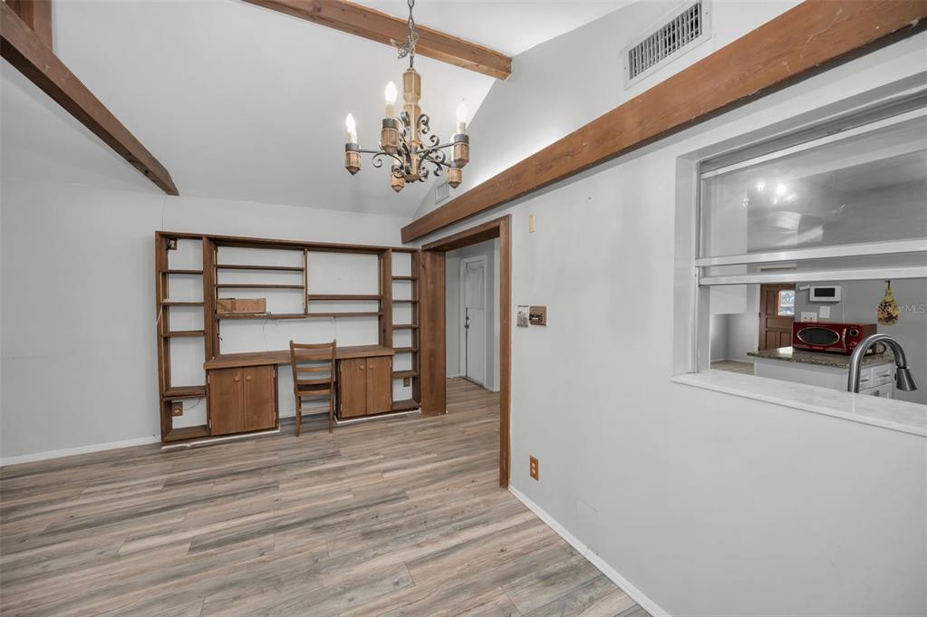 14557 Apache Avenue Largo, FL 33774 - Photo 20 of 50 a view of a livingroom with a furniture hardwood floor and a ceiling fan
