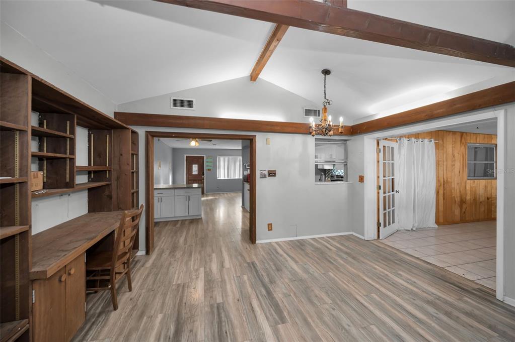 14557 Apache Avenue Largo, FL 33774 - Photo 22 of 51 a view of a hallway with wooden floor and dining room