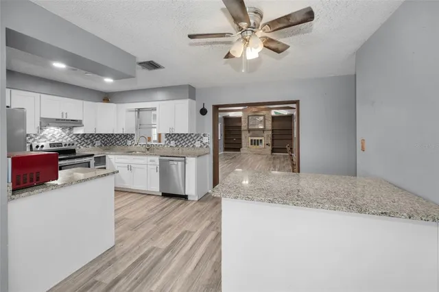 a kitchen with kitchen island a sink stainless steel appliances and counter space