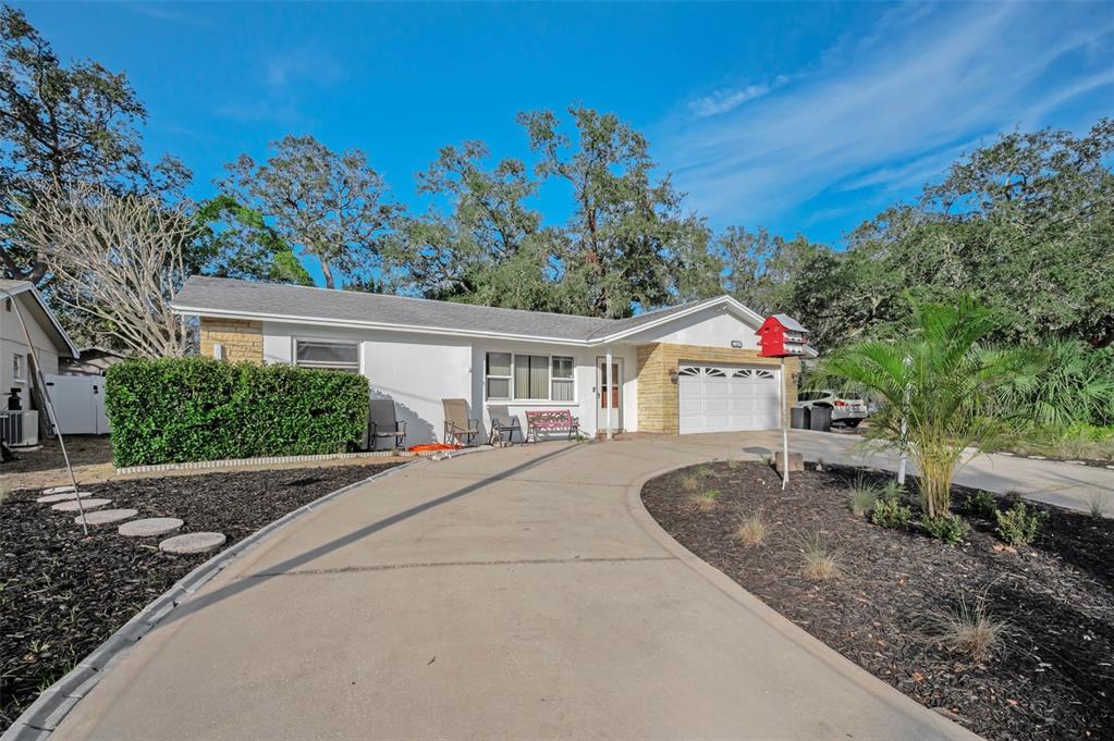 14557 Apache Avenue Largo, FL 33774 - Photo 3 of 51 a front view of a house with garden