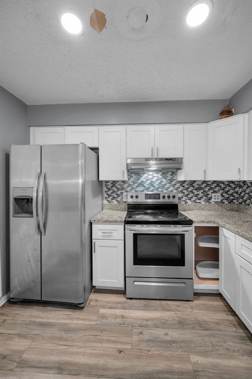 14557 Apache Avenue Largo, FL 33774 - Photo 31 of 51 a kitchen with granite countertop a sink cabinets stainless steel appliances and a counter space