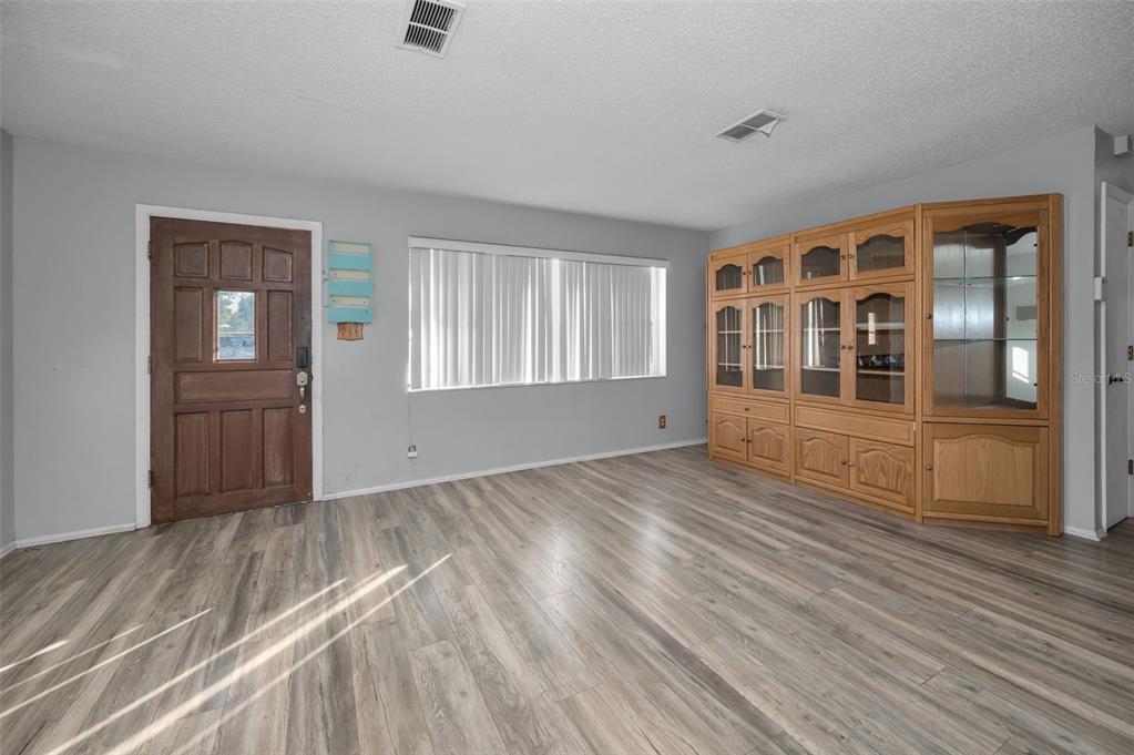 14557 Apache Avenue Largo, FL 33774 - Photo 37 of 51 a view of empty room with wooden floor and fan