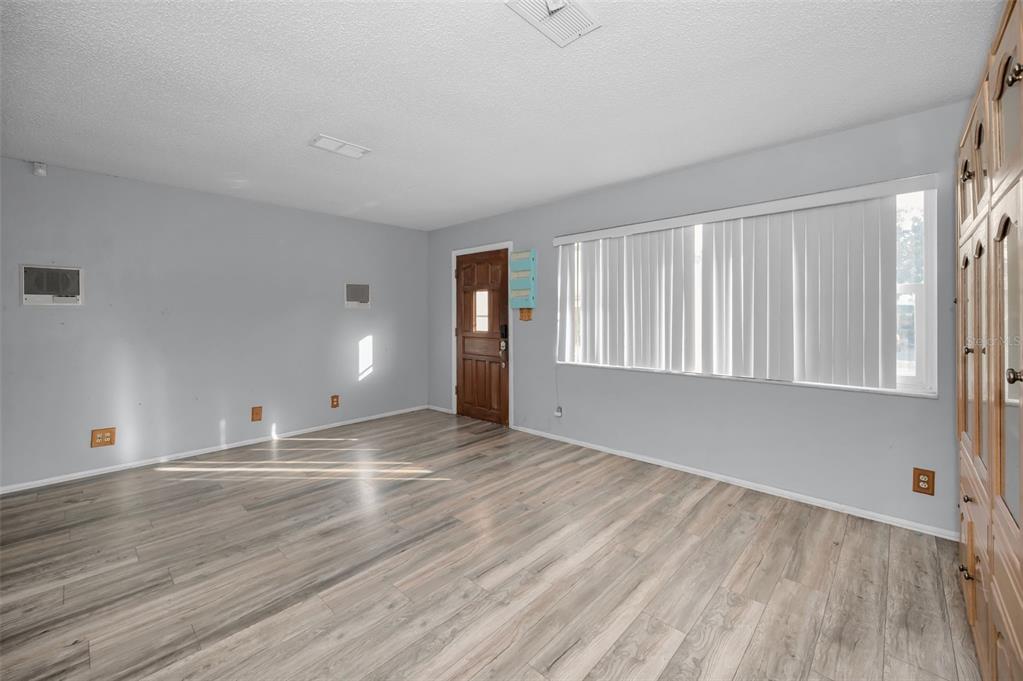14557 Apache Avenue Largo, FL 33774 - Photo 38 of 51 wooden floor in an empty room with a window