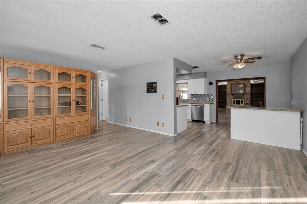 14557 Apache Avenue Largo, FL 33774 - Photo 40 of 51 a view of empty room with wooden floor and kitchen