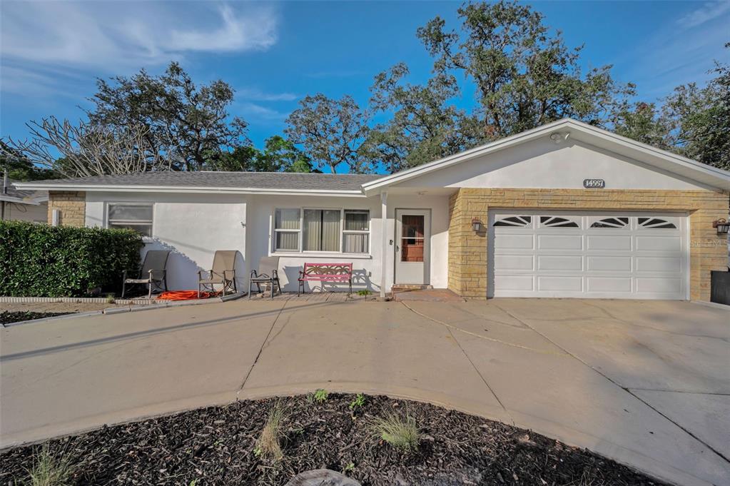 14557 Apache Avenue Largo, FL 33774 - Photo 5 of 51 front view of a house with a yard