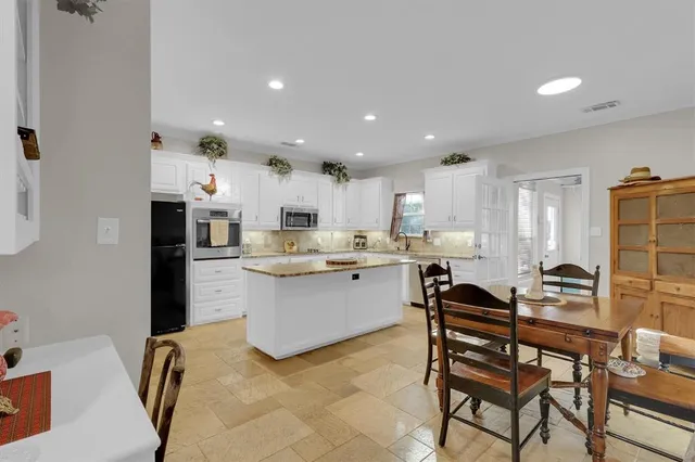 a kitchen with a sink cabinets and window