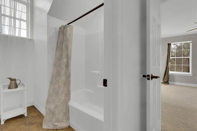 a bathroom with a bathtub and a shower