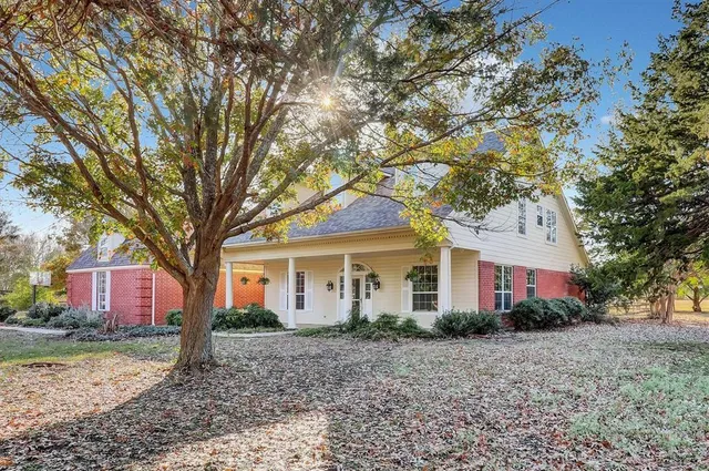 a house that has a tree in front of it