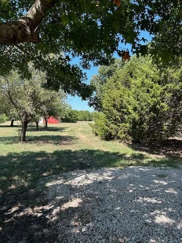 a view of outdoor space with trees all around