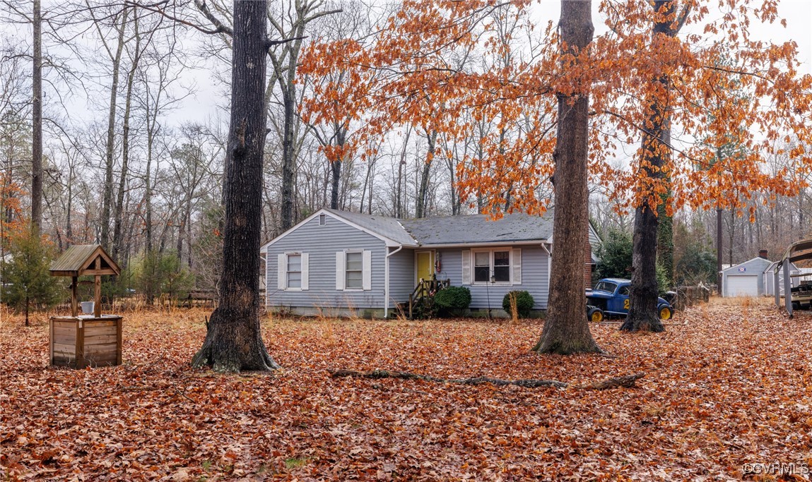 a front view of a house with a yard covered in snow