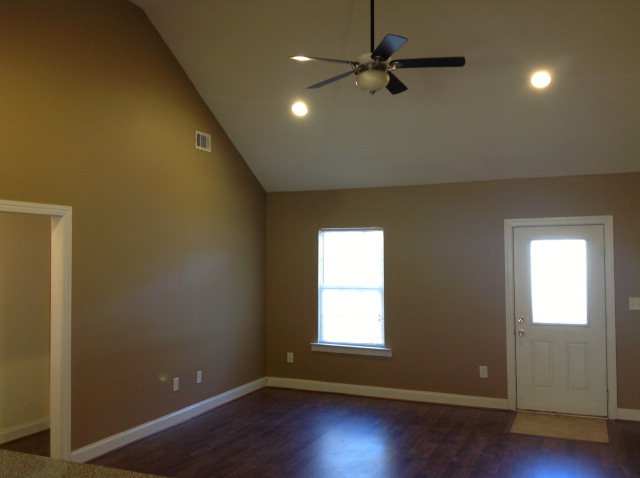 4775 Brookhaven Road Macon, GA 31206 - Photo 4 of 16 an empty room with wooden floor fan and windows