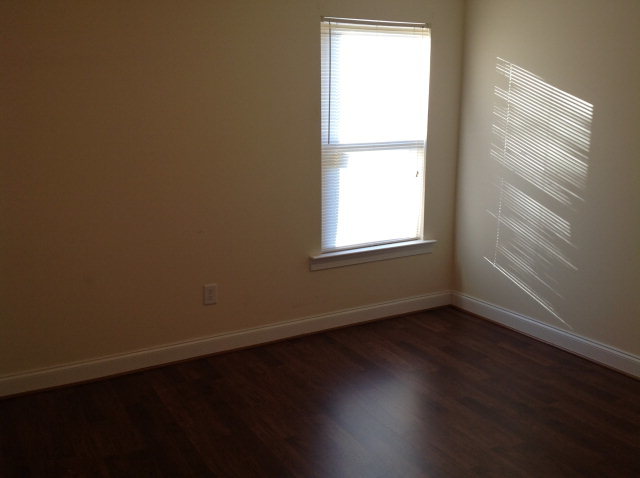 4775 Brookhaven Road Macon, GA 31206 - Photo 9 of 16 an empty room with wooden floor and windows