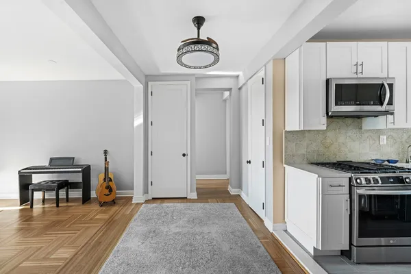 a kitchen with stainless steel appliances granite countertop a stove and a refrigerator