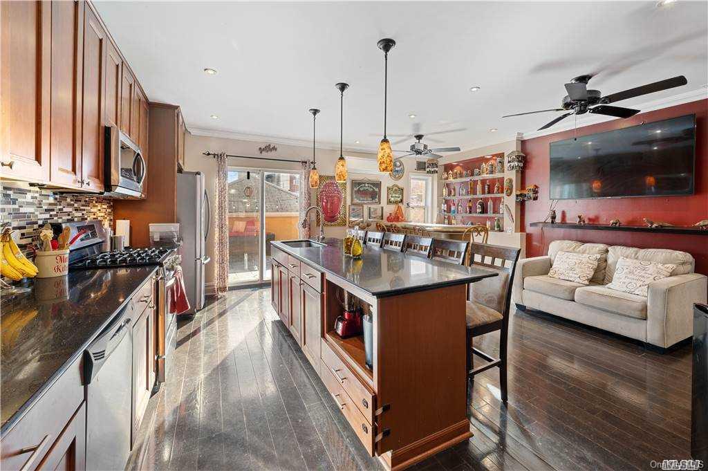 a open kitchen with stainless steel appliances granite countertop a sink and a stove