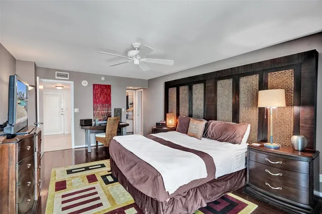 a bed room with a bed window and a television