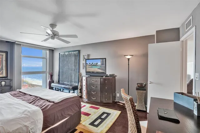 a view of a hallway with wooden floor and a potted plant