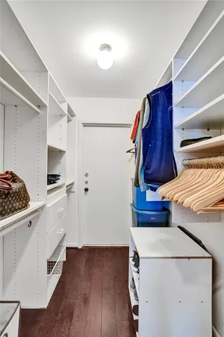 a bathroom with a toilet sink vanity granite and a mirror