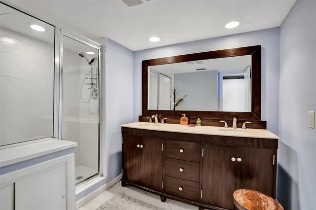 a bathroom with a granite countertop sink a toilet and a mirror