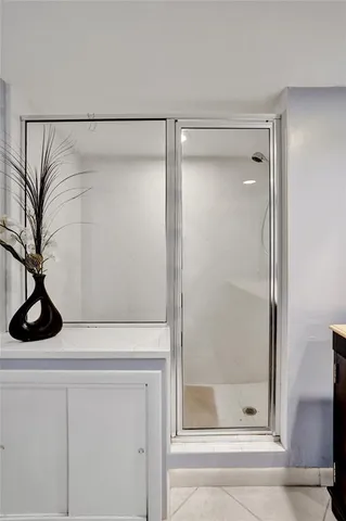 a bedroom with a bed a rug and dresser