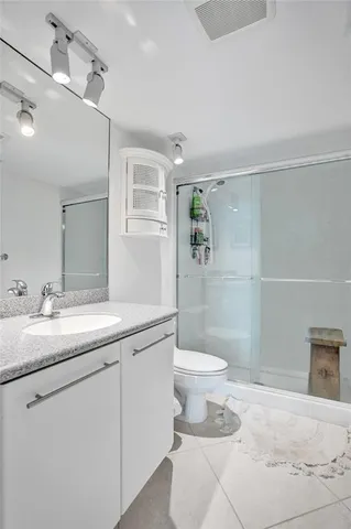 a living room with furniture and a dining table with wooden floor