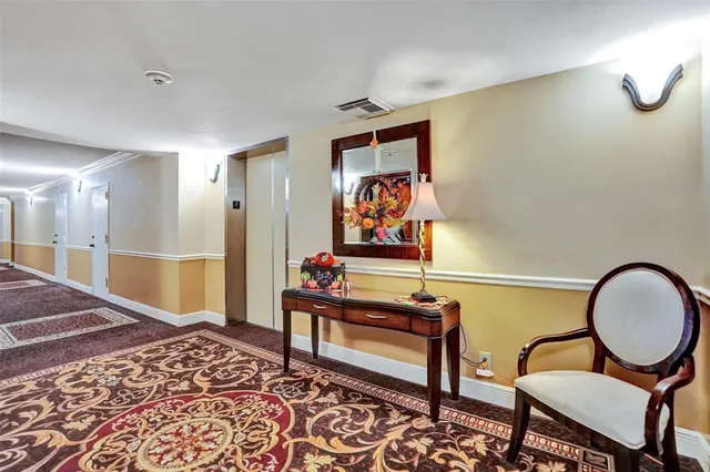 a view of a lobby with a sitting area and potted plants