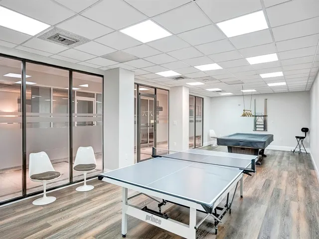 a room with gym equipment and a view of living room