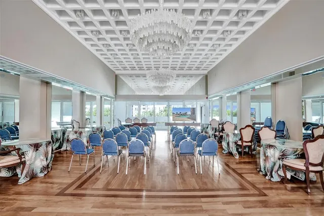a view of a big room with dining room windows and furniture