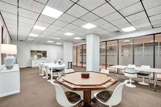 a large kitchen with a table and chairs