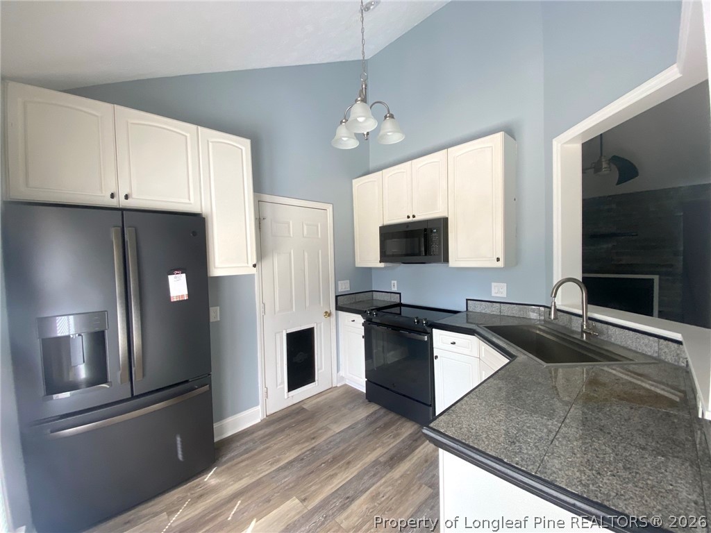 5715 Walkabout Road Hope Mills, NC 28348 - Photo 4 of 16 a kitchen with stainless steel appliances granite countertop a refrigerator and a sink
