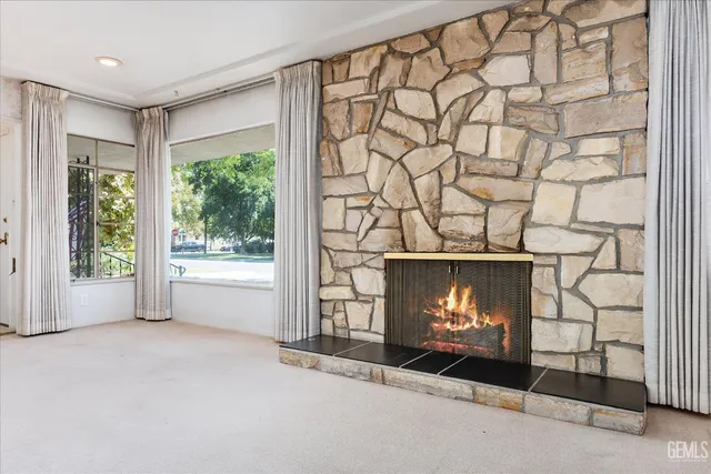 an empty room with furniture and a fireplace