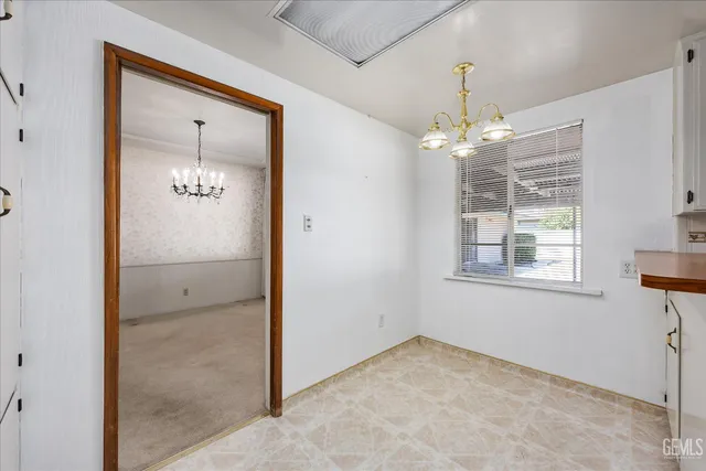 a kitchen with kitchen island a sink appliances and cabinets