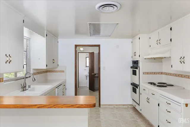 a close view of sink and cabinets