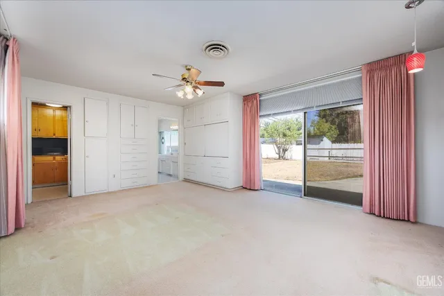 a spacious bathroom with a granite countertop sink a mirror and a shower