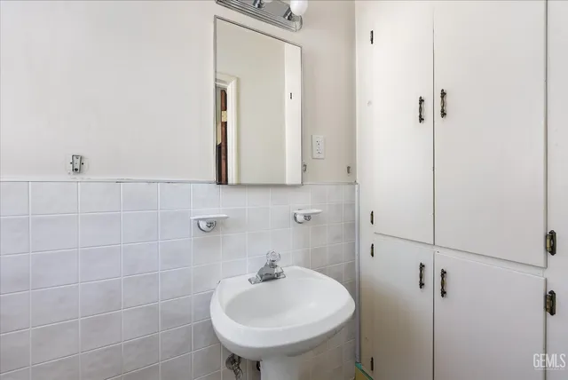 a bathroom with a shower and a sink
