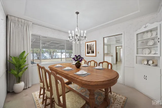 a dining room with furniture potted plants and wooden floor