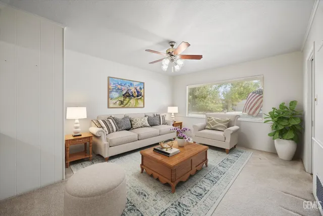 a living room with furniture a chandelier and a window