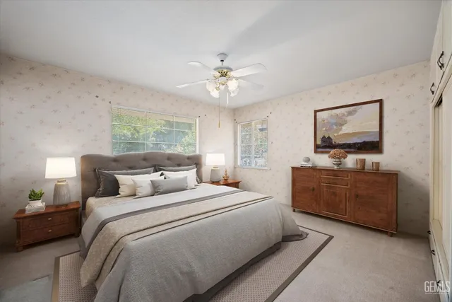 a bedroom with a large bed and a chandelier