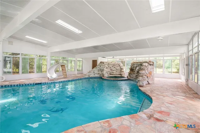 a view of a bathtub in back yard of the house