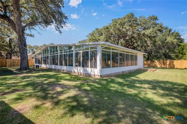 a view of a house with a backyard