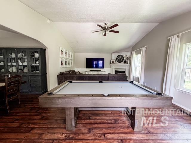 808 O'Leary Way Twin Falls, ID 83301 - Photo 17 of 37 Open-concept room featuring wood-finish flooring, a vaulted ceiling, and a built-in display cabinet
