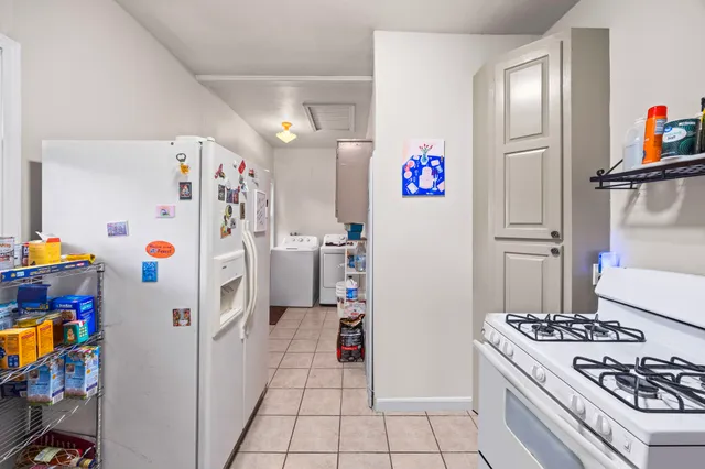 a kitchen with a refrigerator and a stove top oven