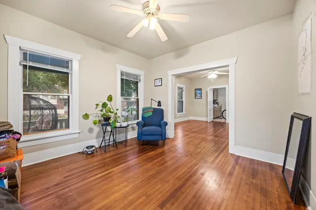 a living room with furniture and a wooden floor