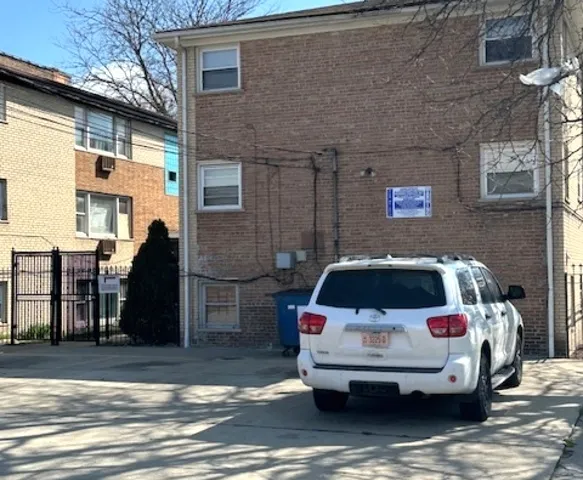 a white car parked in front of a building