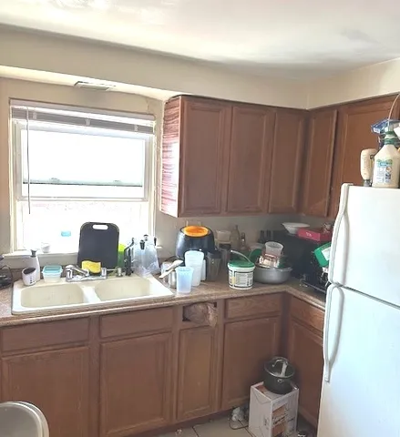 a kitchen with stainless steel appliances granite countertop a refrigerator sink and cabinets
