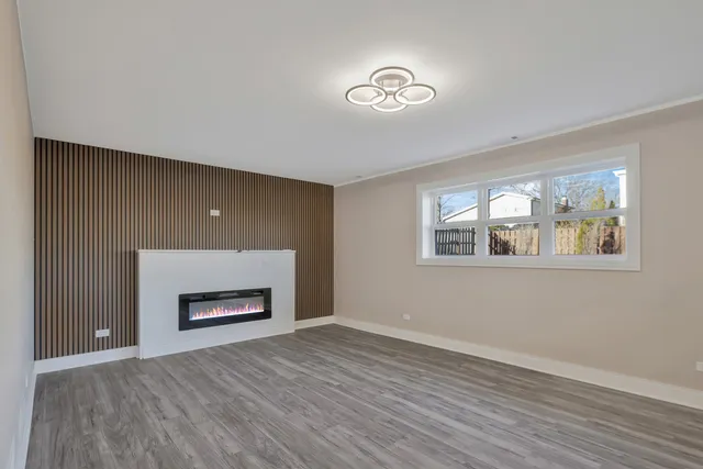 a room with a fireplace and wooden floor